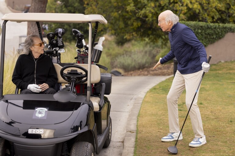 This image released by HBO shows Richard Lewis, left, and Larry David in a scene from Season 12 of "Curb Your Enthusiasm." Lewis, an acclaimed comedian known for exploring his neuroses in frantic, stream-of-consciousness diatribes while dressed in all-black, leading to his nickname “The Prince of Pain,” has died. He was 76. He died at his home in Los Angeles on Tuesday night after suffering a heart attack, according to his publicist Jeff Abraham. (John P. Johnson/HBO via AP)