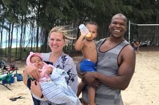 In a 2021 photo provided by Bickerton Law Group representing the family of Lindani Myeni, he is standing on a beach in Waimanalo, Hawaii with his wife and two children. Some Black people in Hawaii say Myeni's shooting death by Honolulu police is a reminder that Hawaii isn't the racially harmonious paradise it's held up to be. (Myeni Family Photo/Bickerton Law Group via AP)