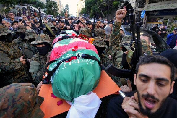 FILE - Islamic Group members known as Jamaa Islamiya carry the body of their comrade Mohammad Riad Mohyeldin, who was killed in an apparent Israeli strike, during his funeral procession in Beirut, Lebanon on March 12, 2024. AP Photo/Bilal Hussein, File)
