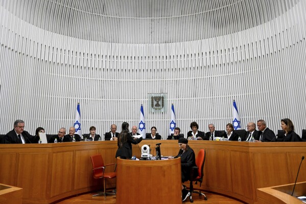 All 15 of Israel's Supreme Court justices appear for the first time in the country's history to look at the legality of Prime Minister Benjamin Netanyahu's contentious judicial overhaul, which the government pushed through parliament in July, in Jerusalem, Tuesday, Sept. 12, 2023. The divisive law, which cancels the court's ability to block government actions and appointments using the legal concept that they are "unreasonable," is the first piece of the wider government plan to weaken the Supreme Court. (Debbie Hill/Pool Photo via AP)