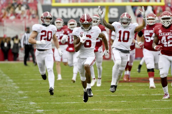 Alabama punt returner DeVonta Smith (6) returns a punt for a touchdown against Arkansas during the first half of an NCAA college football game Saturday, Dec. 12, 2020, in Fayetteville, Ark. (AP Photo/Michael Woods)