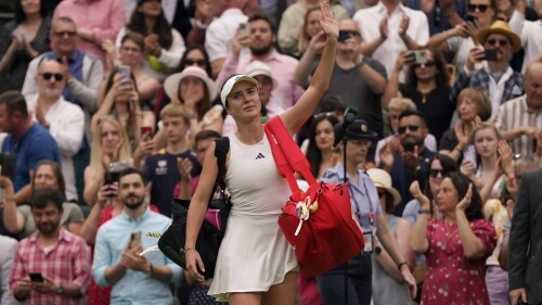 Ukraine's Elina Svitolina waves to the crowd as she leaves court after losing to Czech Republic's Marketa Vondrousova in a women's singles semifinal match on day eleven of the Wimbledon tennis championships in London, Thursday, July 13, 2023. (AP Photo/Alberto Pezzali)