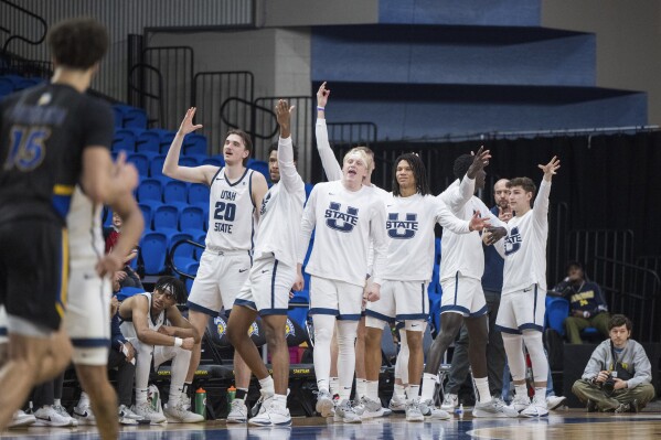 Utah State players cheer a basket during the first half of an NCAA basketball game against the San Jose State Wednesday, March 6, 2024, in San Jose, Calif. (AP Photo/Nic Coury)