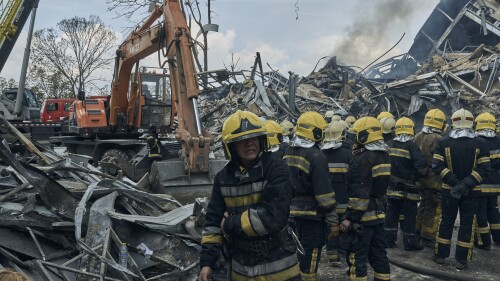 Emergency service personnel work at the site of a destroyed building after a Russian attack in Odesa, Ukraine, Thursday, July 20, 2023. (AP Photo/Libkos)