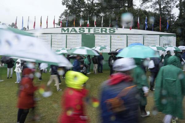 Patrons leave the course after play was suspended for the day in the weather delayed third round of the Masters golf tournament at Augusta National Golf Club on Saturday, April 8, 2023, in Augusta, Ga.(AP Photo/David J. Phillip)