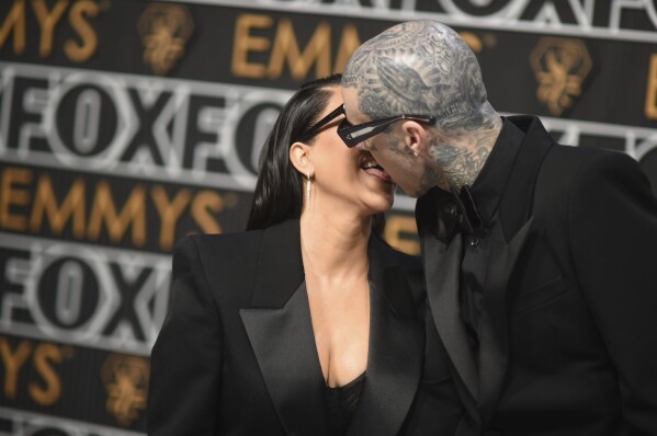 Kourtney Kardashian, left, and Travis Barker arrive at the 75th Primetime Emmy Awards on Monday, Jan. 15, 2024, at the Peacock Theatre in Los Angeles. (Photo by Richard Shotwell/Invision/AP)