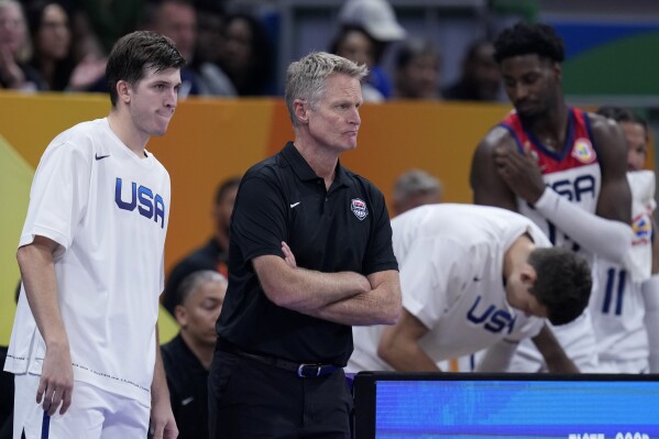 U.S. head coach Steve Kerr, watches the last few moments of their loss to German in a Basketball World Cup semi final game in Manila, Philippines, Friday, Sept. 8, 2023. (AP Photo/Michael Conroy)