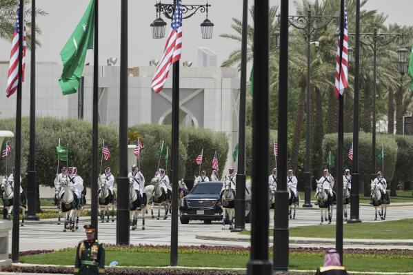 Members of a traditional Saudi honor guard escort the car carrying U.S. President Donald Trump during a welcome ceremony at the Royal Palace in Riyadh, Saudi Arabia, Tuesday, May 13, 2025. (AP Photo/Alex Brandon)
