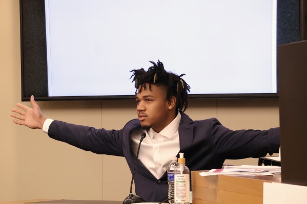 University of Illinois basketball standout Terrence Shannon Jr. demonstrates his wingspan while testifying during his rape trial Thursday June 13, 2024, in Lawrence, Kan. Shannon, of Champaign, Ill., is accused of committing sexual assault on Sept. 9, 2023, in Lawrence, Kan. (Chris Conde/The Lawrence Journal-World via AP)