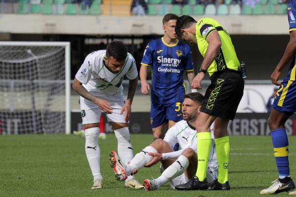 Sassuolo's Domenico Berardi holds his leg after an injury during the Serie A soccer match between Hellas Verona and Sassuolo, at the Marcantonio Bentegodi Stadium in Verona, Italy, Sunday, March 3, 2024. (Paola Garbuio/LaPresse via AP)