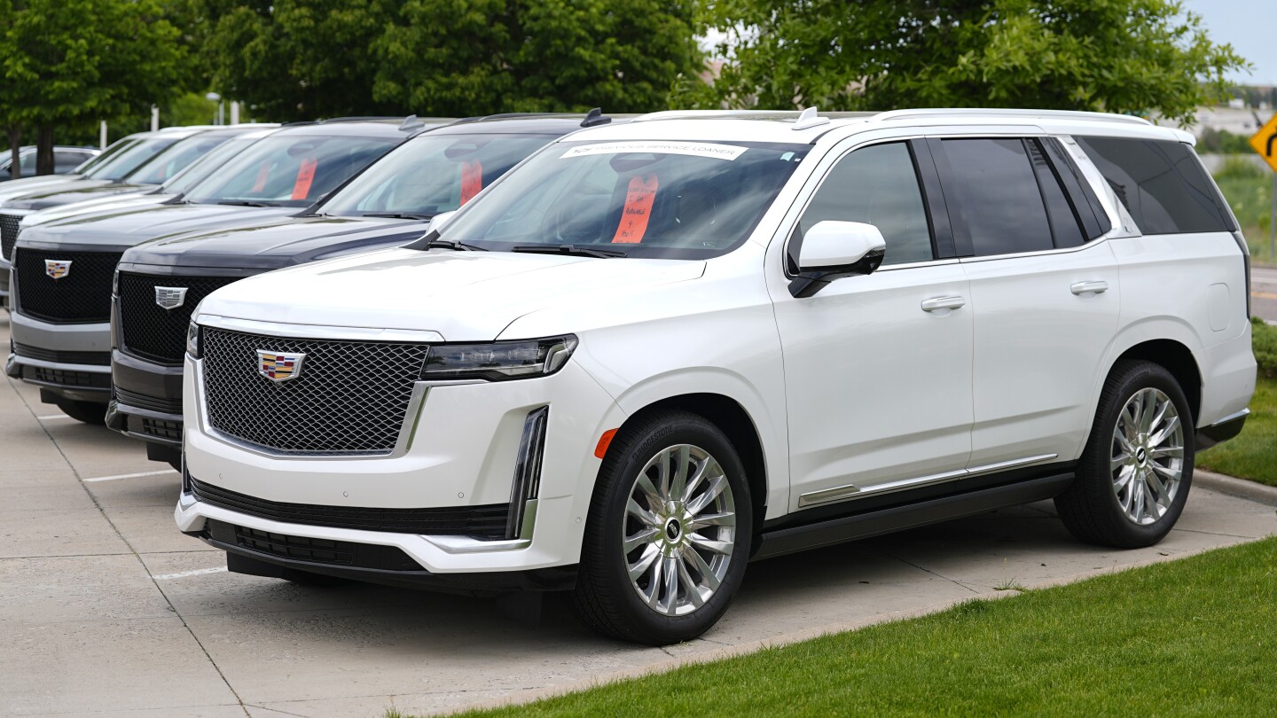 FILE - Unsold 2024 Escalade utility vehicles are parked at a Cadillac dealership on June 2, 2024, in Lone Tree, Colo. (AP Photo/David Zalubowski, File