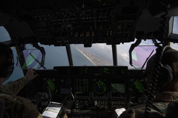 Members of the U.S. Air Force fly over the Mediterranean Sea toward the coast to drop humanitarian aid over Gaza Strip, Thursday, March 14, 2024. (AP Photo/Leo Correa)