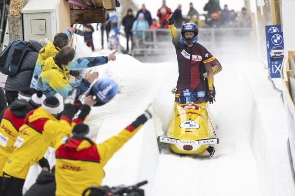 Francesco Friedrich and Team of Germany reacts after the the Men's 4-Bob World Championships in St. Moritz, Switzerland, on Sunday, Feb. 5, 2023. (Mayk Wendt/Keystone via AP)