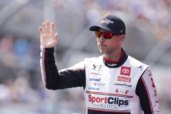NASCAR Cup Series driver Denny Hamlin (11) waves to fans before a NASCAR Cup Series auto race at Darlington Raceway, Sunday, April 6, 2025, in Darlington, S.C. (AP Photo/Scott Kinser)