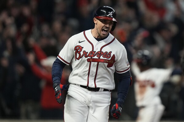 FILE - Atlanta Braves' Adam Duvall celebrates after his grand slam home run during the first inning in Game 5 of baseball's World Series between the Houston Astros and the Atlanta Braves Sunday, Oct. 31, 2021, in Atlanta. Duvall is returning for another stint with the Atlanta Braves, who signed the slugging outfielder on Thursday, March 14, 2024, to a $3 million deal for the 2024 season.(AP Photo/Brynn Anderson, File)