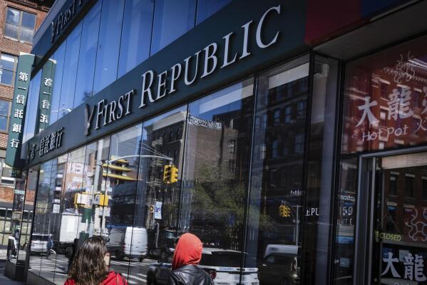 People walk past a First Republic Bank in New York, Monday, May 1, 2023. Regulators seized the troubled First Republic Bank early Monday, making it the second-largest bank failure in U.S. history, and promptly sold all of its deposits and most of its assets to JPMorgan Chase in a bid to stop further banking turmoil that has dominated the first half of this year. (AP Photo/Stefan Jeremiah)