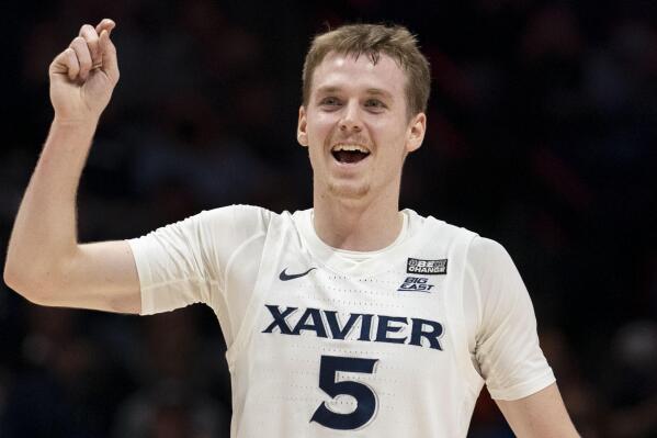 Xavier guard Adam Kunkel (5) reacts after a Zach Freemantle basket during the first half of an NCAA college basketball game against Butler, Wednesday, Feb. 2, 2022, in Cincinnati. (AP Photo/Jeff Dean)