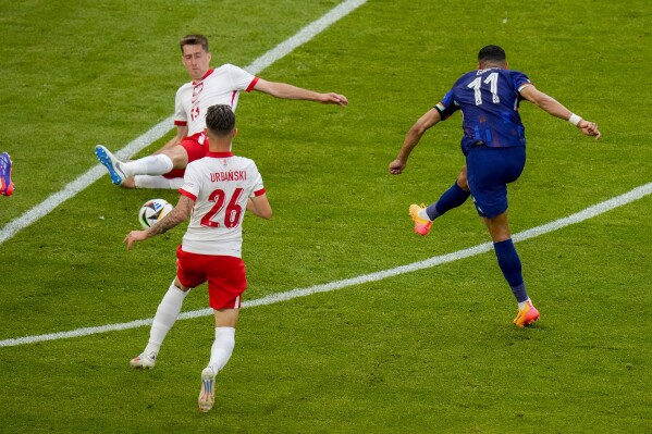 Cody Gakpo of the Netherlands scores his side's equalizing goal during a Group D match between Poland and the Netherlands at the Euro 2024 soccer tournament in Hamburg, Germany, Sunday, June 16, 2024. (AP Photo/Petr Josek)