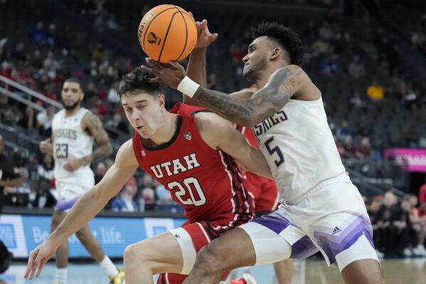 Washington's Jamal Bey (5) drives into Utah's Lazar Stefanovic (20) during the second half of an NCAA college basketball game in the first round of the Pac-12 tournament Wednesday, March 9, 2022, in Las Vegas. (AP Photo/John Locher)