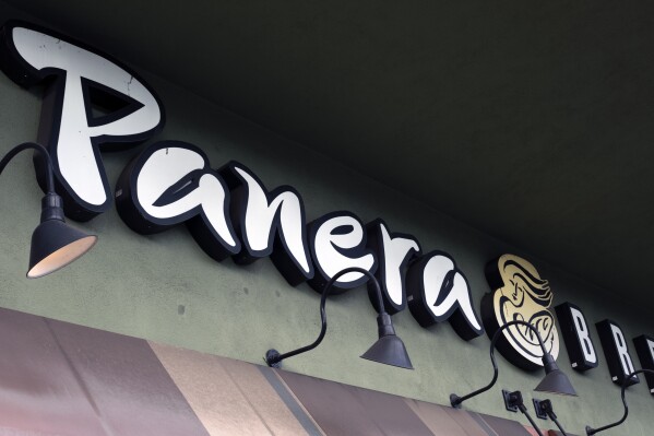 FILE - A Panera Bread sign and logo is attached to the outside of a Panera Bread restaurant location in the Studio City section of Los Angeles, on Thursday, March 7, 2024. Panera Bread said Tuesday, May 7, it's discontinuing its Charged Sips drinks that were tied to at least two wrongful death lawsuits due to their high caffeine content. (AP Photo/Richard Vogel, File)