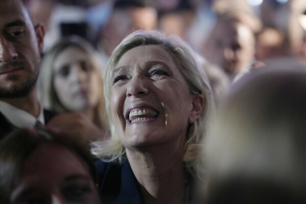 French far right leader Marine Le Pen reacts as she meets supporters and journalists after the release of projections based on the actual vote count in select constituencies in Henin-Beaumont, northern France, Sunday, June 30, 2024. (AP Photo/Thibault Camus)