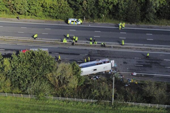 Emergency services at the scene of a coach crash on the M53 motorway, between junction 5 at Ellesmere Port and junction 4 at Bebbington in Hooton, England, Friday Sept. 29, 2023. A bus carrying school children overturned on a highway near Liverpool on Friday. (Peter Byrne/PA via AP)