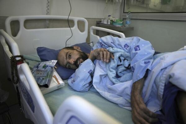 Khalil Awawdeh, a Palestinian who has been on a hunger strike for several months protesting being jailed without charge or trial under what Israel refers to as administrative detention, lies in bed at Asaf Harofeh Hospital in Be'er Ya'akov, Israel, Wednesday, Aug. 24, 2022. Israel's Supreme Court court rejected an appeal by his lawyer on Sunday calling for his immediate release due to his failing medical condition. Around 670 Palestinians are currently being held in administrative detention by Israel. (AP Photo/Mahmoud Illean)