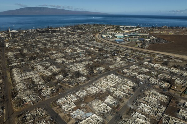 FILE - The aftermath of a wildfire is visible in Lahaina, Hawaii, Aug. 17, 2023. When the most deadly U.S. fire in a century ripped across the Hawaiian island, it damaged hundreds of drinking water pipes, resulting in a loss of pressure that likely allowed toxic chemicals along with metals and bacteria into water lines. Experts are using strong language to warn Maui residents in Lahaina and Upper Kula not to filter their own tap water. (AP Photo/Jae C. Hong, File)