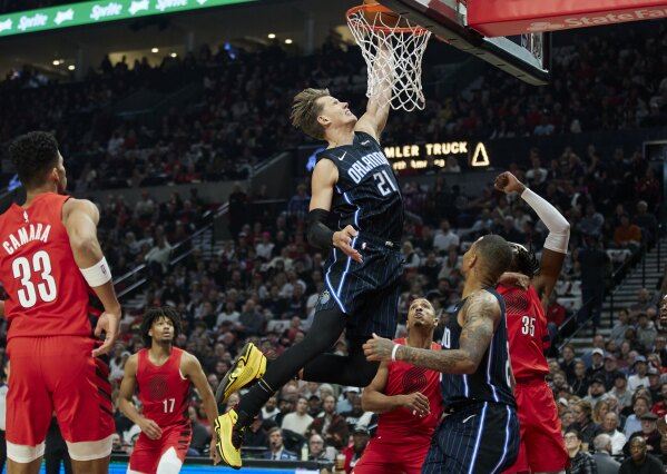 Orlando Magic center Moritz Wagner (21) dunks against the Portland Trail Blazers during the first half of an NBA basketball game in Portland, Ore., Friday, Oct. 27, 2023. (AP Photo/Craig Mitchelldyer)