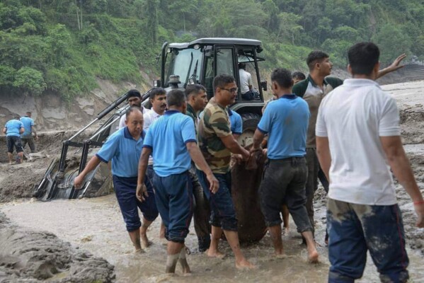 Rescue work continues after flash floods triggered by a sudden heavy rainfall swamped the Rangpo town in Sikkim, India, Thursday, Oct.5. 2023. (AP Photo/Prakash Adhikari)