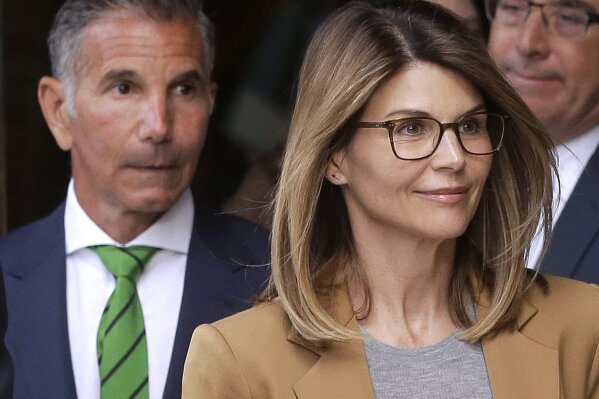 
              FILE - In this April 3, 2019 file photo, actress Lori Loughlin, front, and husband, clothing designer Mossimo Giannulli, left, depart federal court in Boston after facing charges in a nationwide college admissions bribery scandal. Loughlin and her husband Giannulli said in court documents Monday, April 15, 2019, that they are pleading not guilty to charges that they took part in a sweeping college admissions bribery scam.  (AP Photo/Steven Senne, File)
            