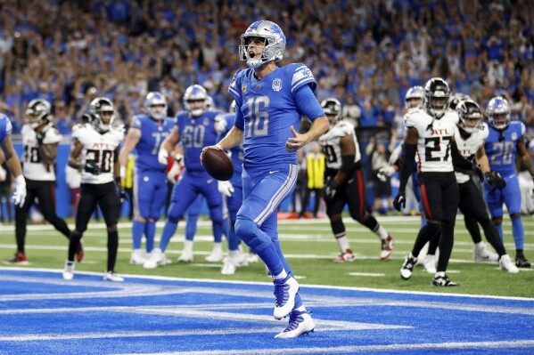 Detroit Lions quarterback Jared Goff (16) scores a touchdown against the Atlanta Falcons in the second half of an NFL football game Sunday, Sept. 24, 2023, in Detroit. (AP Photo/Al Goldis)