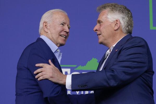 President Joe Biden greets Virginia democratic gubernatorial candidate Terry McAuliffe as he arrives to speak at a campaign event for McAuliffe at Lubber Run Park, Friday, July 23, 2021, in Arlington, Va. (AP Photo/Andrew Harnik)