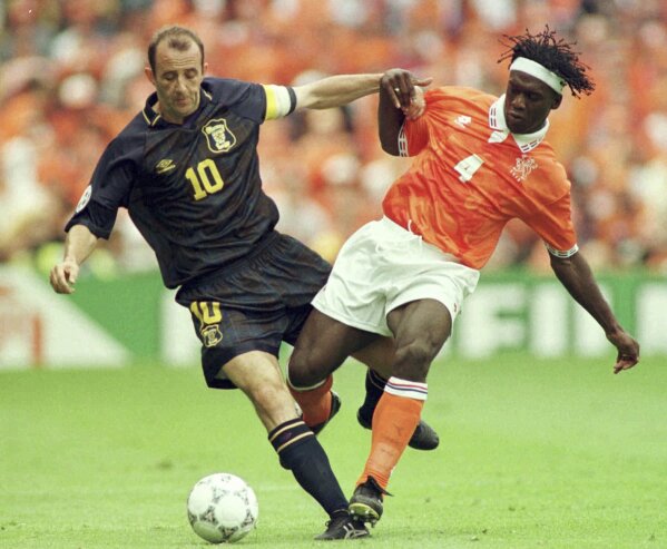 FILE - Gary McAllister of Scotland, left, challenges Clarence Seedorf of The Netherlands during their Group A match at The European Soccer Championships at Villa Park in Birmingham Monday June 10, 1996. Host nation Germany may be the heavyweight in its European Championship group, but any of Scotland, Hungary or Switzerland is capable of causing an upset in Group A. (AP Photo/Michael Probst, File)