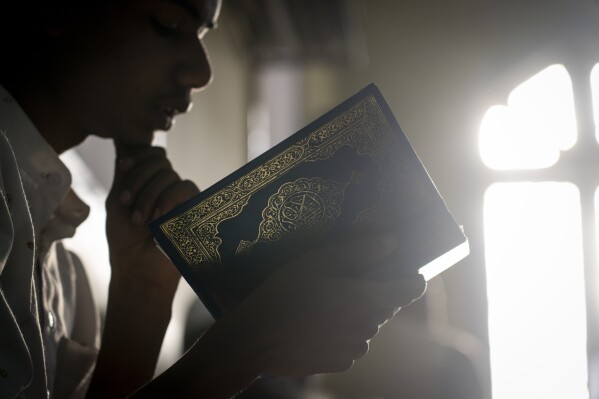 A Nepalese Muslim recites Quran at the Jame Mosque on the first day of holy month of Ramadan in Kathmandu, Nepal, Tuesday, March 12, 2024. (AP Photo/Niranjan Shrestha)