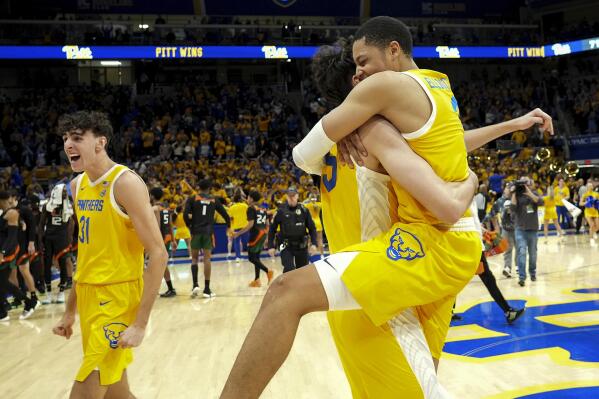 Pittsburgh forward Jorge Diaz Graham (31), forward Guillermo Diaz Graham (25) and guard Greg Elliott (3) celebrate after defeating Miami, 71-68, in an NCAA college basketball game in Pittsburgh, Saturday, Jan. 28, 2023. (AP Photo/Matt Freed)