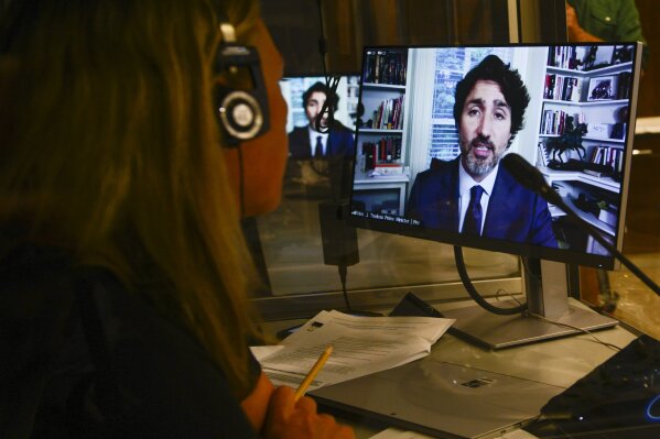 A translator works in their booth as Prime Minister Justin Trudeau appears as a witness via videoconference during a House of Commons finance committee in the Wellington Building on Thursday, July 30, 2020. The committee is looking into Government Spending, WE Charity, and the Canada Student Service Grant. (Sean Kilpatrick/The Canadian Press via AP)