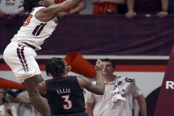 Virginia Tech's Justyn Mutts (25) scores over Louisville's El Ellis (3) during the first half of an NCAA college basketball game Tuesday, March 1, 2022, in Blacksburg, Va. (Matt Gentry/The Roanoke Times via AP)