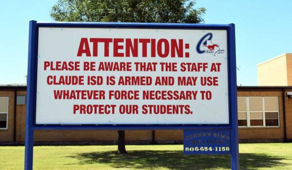 
              This August 2016 photo shows a sign outside a school in Claude, Texas, which Claude ISD posts outside their schools. In the aftermath of yet another mass school shooting, President Donald Trump says that if one of the victims, a football coach, had been armed “he would have shot and that would have been the end of it.” Revisiting an idea he raised in his campaign, Trump’s comments in favor of allowing teachers to be armed come as lawmakers in several states are wrestling with the idea, including in Florida, where the 17 most recent school shooting victims are being mourned.(Creede Newton/Amarillo Globe-News via AP)
            