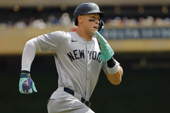 FILE - New York Yankees' Aaron Judge scores from second base on a double by Gleyber Torres during the first inning of a baseball game against the Minnesota Twins, Thursday, May 16, 2024, in Minneapolis. Aaron Judge prides himself an old-school New York Yankee, and now he has a road uniform to match. His suggestion three years ago led to the team jettisoning the away jerseys used for the past half-century in favor of a return to retro, without the white piping instituted during a bleak period in the early 1970s. (AP Photo/Bruce Kluckhohn, File)