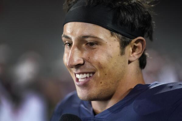 Illinois quarterback Tommy DeVito smiles as he gives a television interview after the team's 31-0 win over Chattanooga in an NCAA college football game Thursday, Sept. 22, 2022, in Champaign, Ill. (AP Photo/Charles Rex Arbogast)