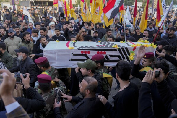 Members of an Iraqi Shiite militant group carry the coffin during the funeral of a fighter with the Kataib Hezbollah, who was killed in a U.S. airstrike, in Baghdad, Iraq, Thursday, Jan. 25, 2024. (AP Photo/Hadi Mizban)