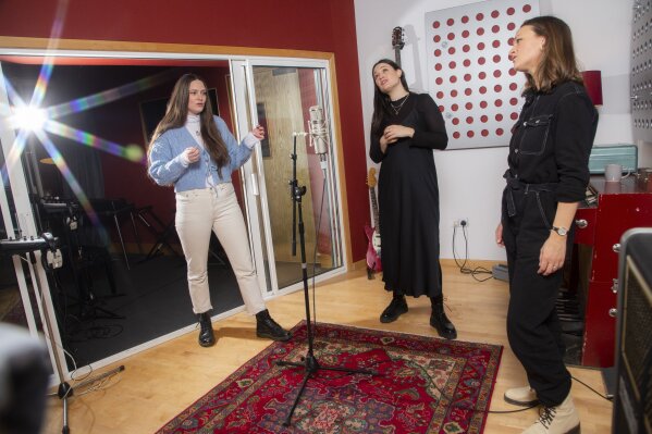 Members of the folk group The Staves, sisters, from left, Camilla, Jessica and Emily Staveley-Taylor rehearse a song in a north London recording studio on Feb. 15, 2021. The Staves released their third album, “Good Woman,” last month. (Photo by Joel C Ryan/Invision/AP)
