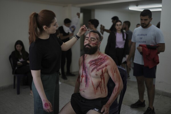 Charbel Joseph Antoun, 37, has makeup applied before portraying Jesus in a Good Friday reenactment at the Maronite Church of St. George in Quraye, near the southern port city of Sidon, Lebanon, Friday, April 18, 2025. (AP Photo/Hassan Ammar)