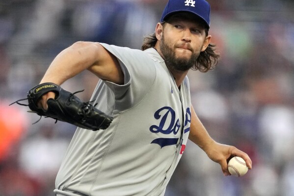 FILE - Los Angeles Dodgers' Clayton Kershaw winds up during a baseball game against the San Francisco Giants in San Francisco, Sept. 30, 2023. Kershaw says he will return for his 17th season with the Dodgers. He says he will be back with the team as part of an agreement that includes a player option for 2025. (AP Photo/Jeff Chiu, File)