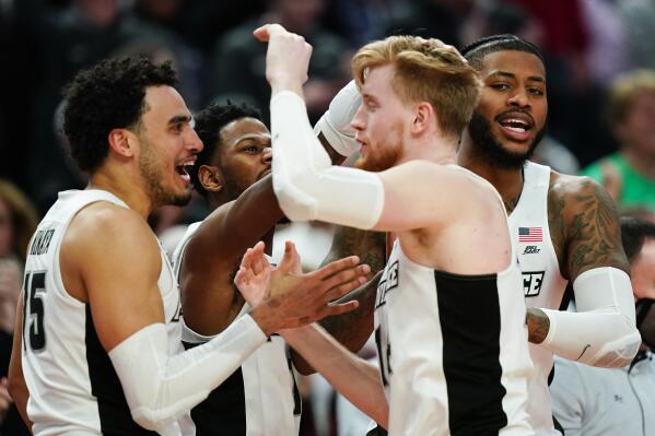 Providence players celebrate on the sideline late in the college basketball game against Richmond in the second round of the NCAA men's tournament Saturday, March 19, 2022, in Buffalo, N.Y. (AP Photo/Frank Franklin II)