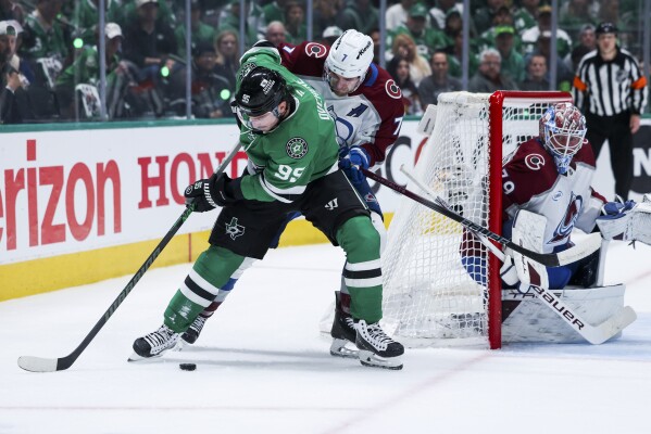 Dallas Stars center Matt Duchene (95) looks to shoot around Colorado Avalanche defenseman Devon Toews (7) during a first-round NHL hockey playoff game in Dallas, Saturday, April 19, 2025. (AP Photo/Gareth Patterson)