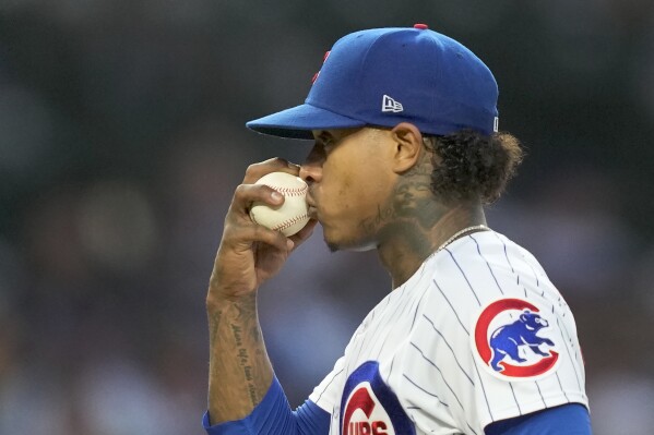 Chicago Cubs' Marcus Stroman kisses the ball before pitching during the fourth inning of the team's baseball game against the St. Louis Cardinals on Thursday, July 20, 2023, in Chicago. (AP Photo/Charles Rex Arbogast)