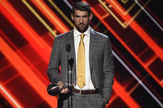 FILE - Michael Phelps accepts the award for best record-breaking performance at the ESPYS on July 12, 2017, in Los Angeles. Olympians including Phelps, Apolo Ohno and Jeremy Bloom are opening up about their mental health struggles in a new sobering documentary about suicide and depression among the world's greatest athletes. Many of the athletes are sharing their pain for the first time in HBO's "The Weight of Gold," which aims to expose the problem, incite change among Olympics leadership and help others experiencing similar issues feel less alone. (Photo by Chris Pizzello/Invision/AP, File)