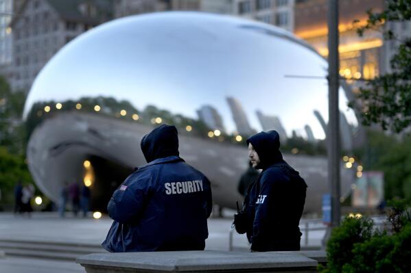 *Private security personnel patrol the area around Anish Kapoor's stainless steel sculpture Cloud Gate, also known as "The Bean," in Chicago's Millennium Park Thursday, May 25, 2023. Chicago is heading into the Memorial Day weekend hoping to head off violence that tends to surge with rising temperatures of summer. Even the state of Illinois is assisting by sending in what it's called "peacekeepers" in an attempt to deescalate violent situations. (AP Photo/Charles Rex Arbogast)